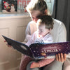Mama und Kind machen es sich gemütlich und lesen eine Geschichte aus ihrem personalisierten Weihnachtsbuch.
